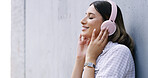 Happy woman, listening and music with headphones for vibe on a wall background or space. Calm, female person or model with smile, relax or earphones for audio streaming, sound playlist or podcast