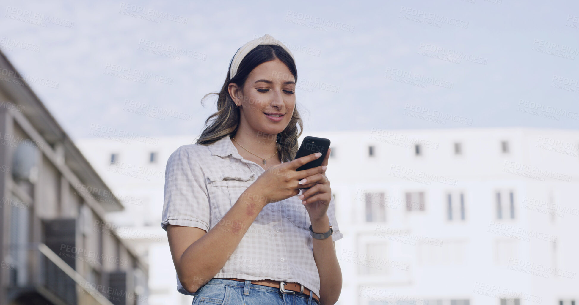 Buy stock photo Low angle, smile and woman in city with phone, post reaction or chat update on digital app. Happy, reading and girl in town with mobile, internet scroll and online messaging on social media.