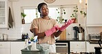 Cleaning, gloves and black woman in kitchen with spray bottle for hygiene, disinfection and bacteria. Housekeeping, routine and person with detergents, cloth and products for maintenance in home