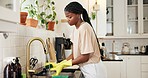 Black woman, kitchen and washing dishes at sink with gloves, chores and dirt removal at apartment. African person, water and faucet for bacteria, cleaning and routine for hygiene in morning at house