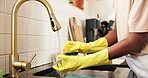 Hands, kitchen and washing dishes at sink with gloves, sponge and dirt removal at apartment. Person, water and faucet with chores for bacteria, cleaning or routine for hygiene in morning at house