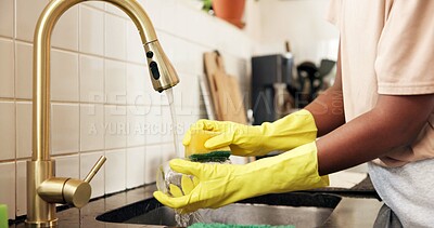 Buy stock photo Hands, kitchen and washing dishes at sink with gloves, sponge and dirt removal at apartment. Person, water and faucet with chores for bacteria, cleaning or routine for hygiene in morning at house