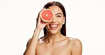 Skincare, grapefruit and portrait of woman in studio with natural, health or wellness routine. Happy, vitamin c and person with citrus fruit for brightening, glow or cleanse face by white background.