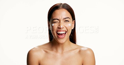 Buy stock photo Woman, wink and skincare cream in studio portrait, pride or laugh with lotion on white background. Person, excited and smile with moisturizer, funny and hydration with benefits for beauty in Mexico