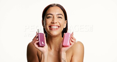 Buy stock photo Woman, beauty and bottle for skincare in studio with smile, mockup space and portrait on background. Gen z girl, cosmetics and happy with product placement, dermatology and container in Colombia