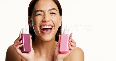 Buy stock photo Woman, happy and bottle for skincare in studio for smile, mockup space or portrait on background. Person, cosmetics and beauty with product placement, dermatology or wink with container in Colombia