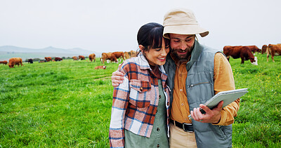 Buy stock photo Happy couple, entrepreneur and tablet with cows on field, hug and agriculture in dairy farming. Sustainable, agro business and people with support for increase milk production, tech and teamwork