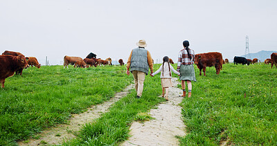 Buy stock photo Farm, cows and back of parents with child in field for bonding, sustainability and agriculture. Family, countryside and mom, dad and girl holding hands for walking, cattle production and environment