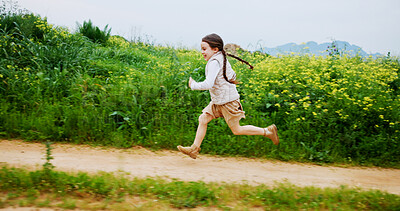 Buy stock photo Excited, running and space with girl outdoor in countryside for child development or growth. Adventure, energy and path with happy kid in green nature for activity, journey or wilderness experience