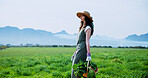 Walking, farmer and woman with carrots, harvest and natural produce for sustainable business or farm. Outdoor, person and vegetables in countryside, gardening and growth for agriculture and space