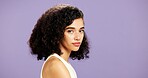 Portrait, beauty and woman in studio for hairstyle, natural cosmetology and mockup space. Face, curly hair and confident model with salon cosmetics, gen z aesthetic and texture on purple background