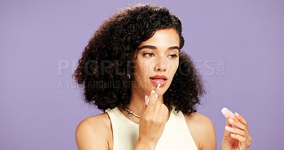 Buy stock photo Cosmetics, lip gloss and skincare with woman in studio for hydration or moisturizer application. Aesthetic, beauty and mouth product with African model isolated on purple background for dermatology
