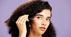 Woman, serum and dropper with beauty for skincare or hydration on a purple studio background. Female person, model or liquid with vitamin C oil for facial treatment, hyperpigmentation or antiaging