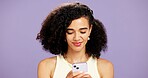 Woman, typing or reading with phone in studio for online chatting or texting on a purple background. Female person, model or smile with mobile smartphone for app connectivity, network or web service