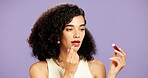 Beauty, lip gloss and skincare with woman in studio for hydration or moisturizer application. Aesthetic, cosmetics and mouth product with African model isolated on purple background for dermatology