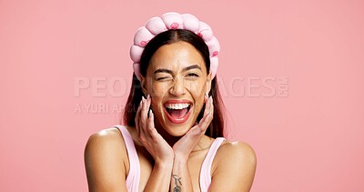 Buy stock photo Wink, skincare and portrait of woman in studio with natural, beauty and wellness for face. Excited, cosmetics and female person with flirting facial expression for dermatology glow by pink background