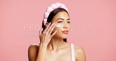 Buy stock photo Moisturizer, skincare and woman in studio with face cream, beauty and facial routine for wellness. Cosmetic, hydration and female person with dermatology lotion, spf or sunscreen by pink background.