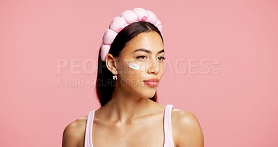 Buy stock photo Beauty, skincare and woman in studio with face cream, moistrurizer and facial routine for wellness. Cosmetic, hydration and female person with dermatology lotion, spf or sunscreen by pink background.