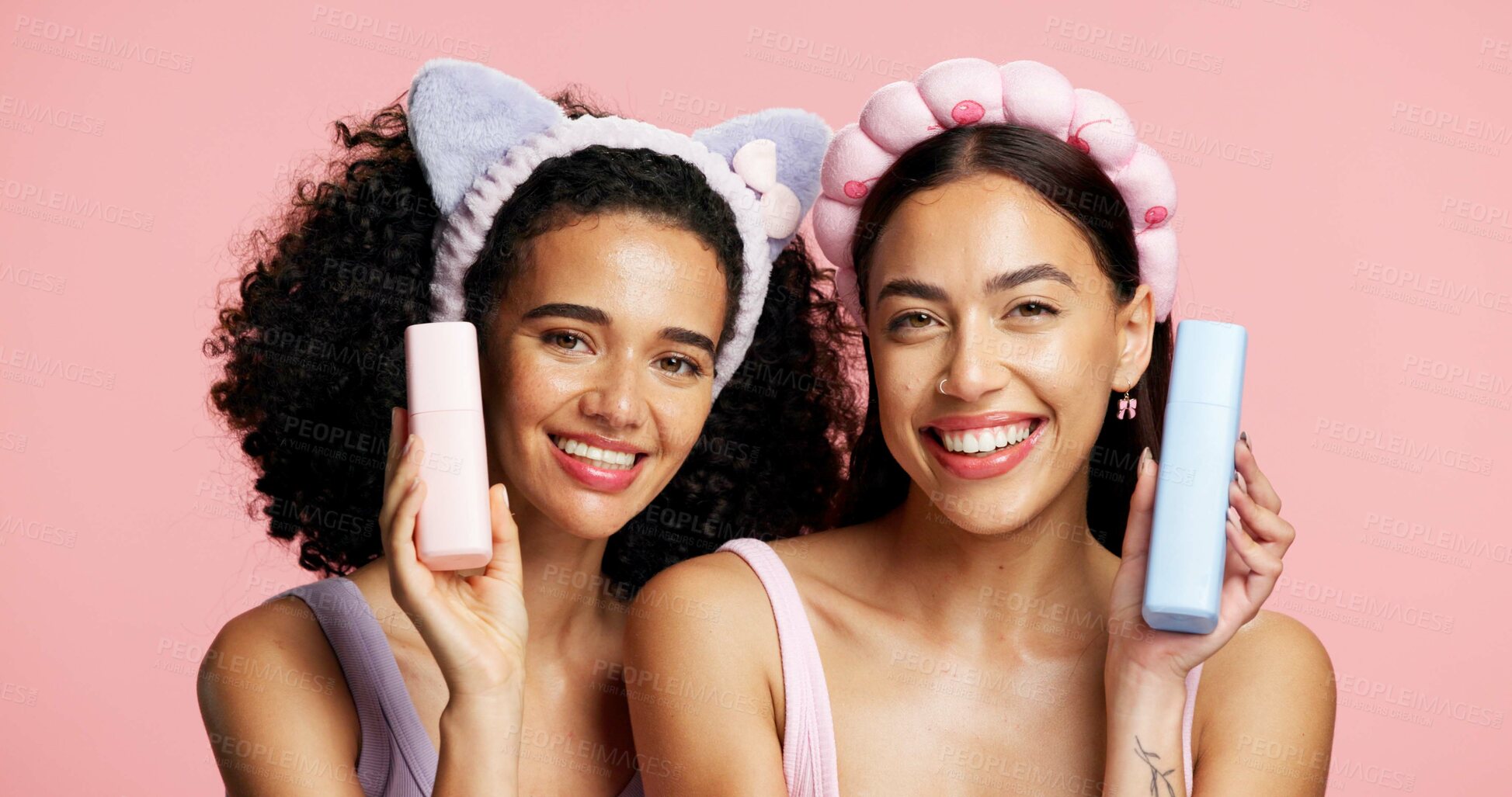 Buy stock photo Skincare products, happy and portrait of girl friends in studio for clean, beauty or cosmetic routine. Smile, health and female influencers with dermatology treatment for wellness by pink background.