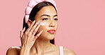 Thinking, woman and sunscreen for skincare in studio for hydration, healthy skin and collagen. Vision, person and lotion for moisturizing, smooth textures and spf benefits for glow on pink background