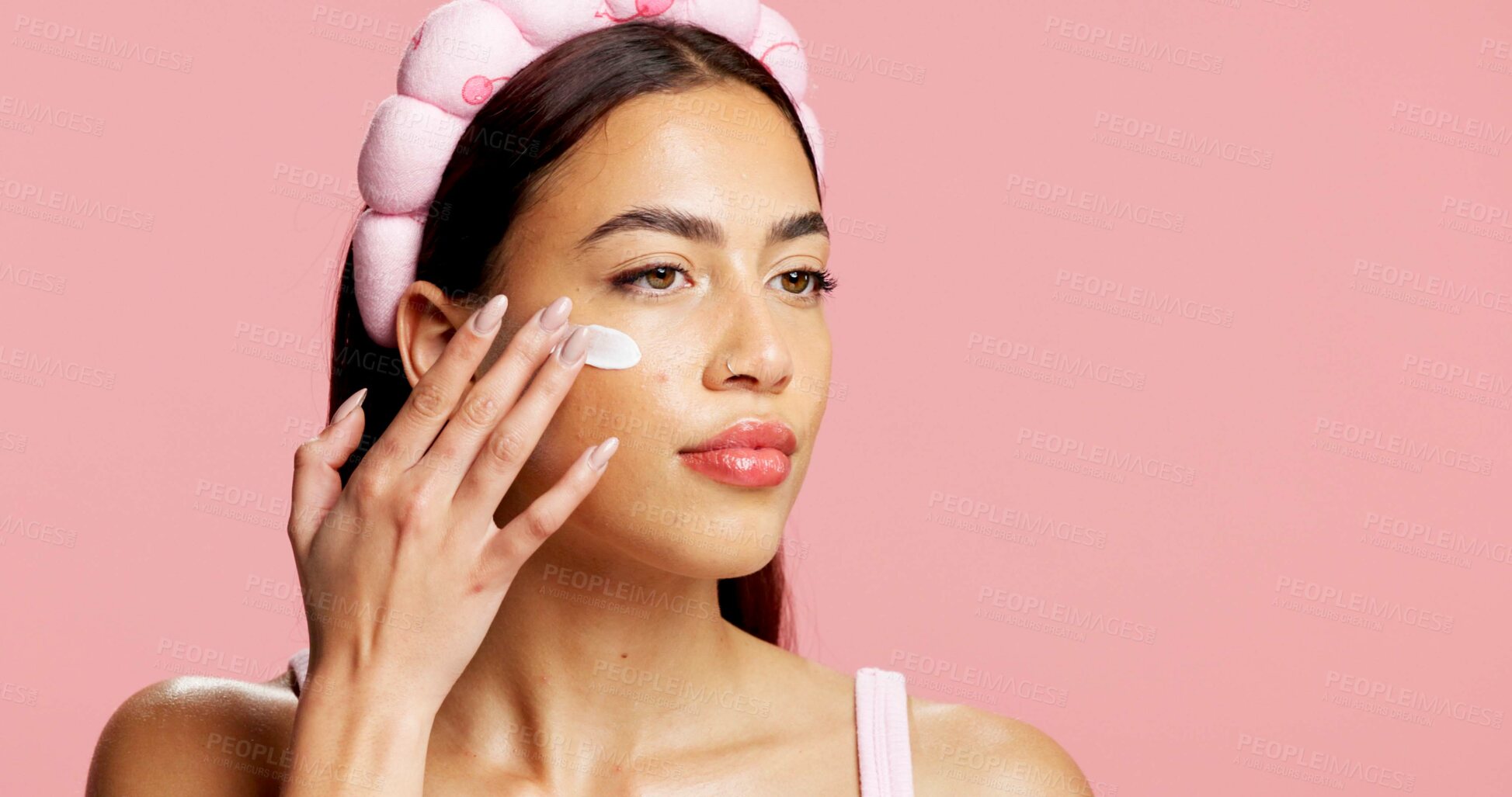 Buy stock photo Thinking, woman and sunscreen for skincare in studio for hydration, healthy skin and collagen. Mockup space, person and lotion for moisturizing, smooth textures and spf benefits on pink background