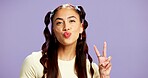 Beauty, portrait and pout with woman in studio for cosmetics, dermatology or skincare excitement. Gen z, hairstyle and peace sign with happy model isolated on purple background for satisfaction