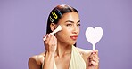 Makeup, mirror and brush woman in studio for cosmetics, contour and beauty maintenance. Self care, glow and blush tools with person on purple background for highlighter shine, foundation and gen z