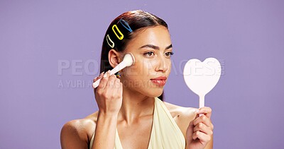 Buy stock photo Makeup, mirror and brush woman in studio for cosmetics, contour and beauty maintenance. Self care, glow and blush tools with person on purple background for highlighter shine, foundation and gen z