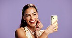 Beauty, finger heart and selfie with influencer woman in studio for product review on social media. App, smile and tongue out playful content creator isolated on purple background for post or update