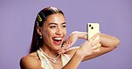 Beauty, energy and selfie with influencer woman in studio for product review on social media. App, haircare and smile of excited content creator isolated on purple background for post or update
