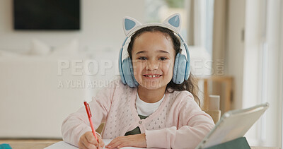 Buy stock photo Home, portrait and child with headphones, writing and listening to audio lesson or online education. Happy, student and girl with tech for homework, elearning and cognitive development with notebook
