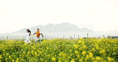 Buy stock photo Canola field, running and couple in nature for adventure, fun and exploring together on summer holiday. Space, outdoor and man with woman for bonding in flower environment in countryside for vacation