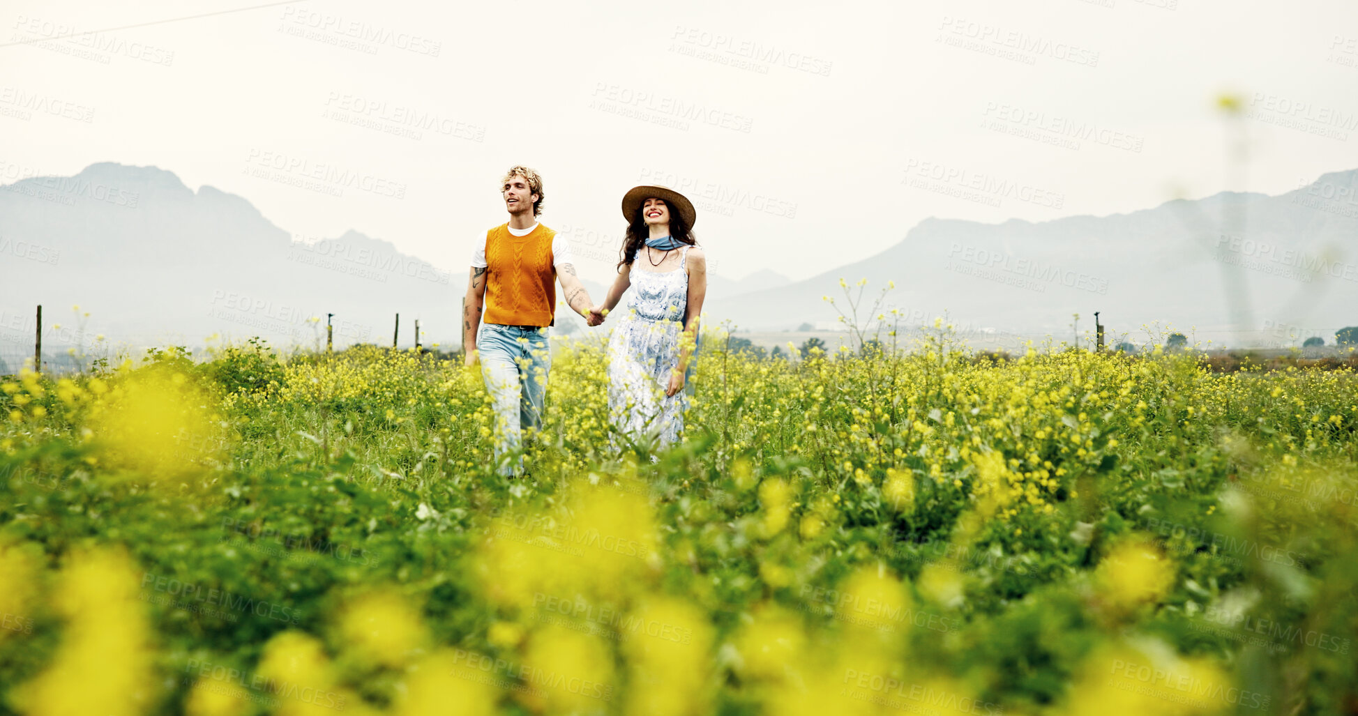 Buy stock photo Canola farm, walking and couple in nature for adventure, fun and exploring together on summer holiday. Field, outdoor and man with woman for bonding in flower environment in countryside for vacation.