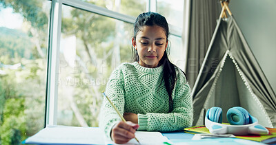 Buy stock photo Homework, learning and notebook with girl student at desk n home for development or growth. Education, school study and writing with child learner in apartment for assessment, knowledge or solution