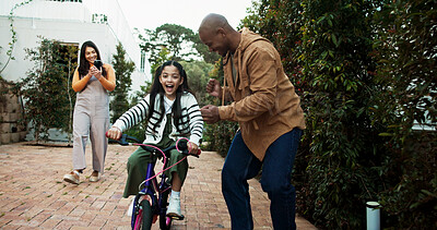 Buy stock photo Parents, bicycle and girl with learning, celebration or recording video with phone, memory and bonding. People, mother and father with child, smartphone or photography for teaching with goals on bike