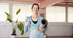 Bottle, portrait and yoga mat with woman in studio for fitness, holistic health or wellness. Hydration, water and smile with happy yogi person in class for commitment or dedication to exercise