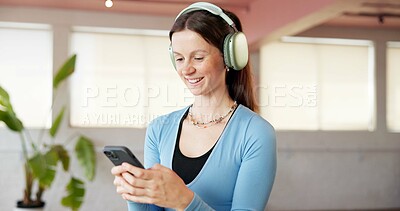 Buy stock photo Fitness, headphones and woman in studio, cellphone and listening to music, app or exercise. Smartphone, audio or happy person in health club, podcast or radio with playlist album, wellness or pilates
