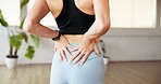 Fitness, hands and woman with back pain in studio from yoga injury, muscle tension and inflammation. Yogi, person and spine fracture at wellness club from exercise mistake, herniated disc and sprain