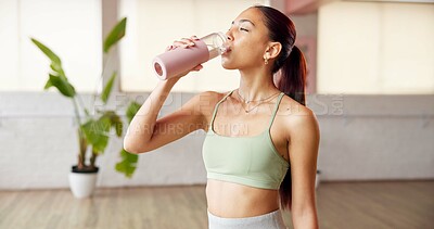 Buy stock photo Fitness, drinking water and woman in yoga studio, indoor exercise and hydration on workout break. Thirsty, refreshing liquid and person gulp from bottle for recovery, pause and rest in health club.