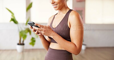 Buy stock photo Phone, smile and hands of woman in yoga studio typing for communication with online app. Fitness, gym and female person with technology for networking, contact and social media in pilates class