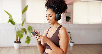 Buy stock photo Phone, smile and headphones with woman in yoga studio for podcast with online app. Fitness, gym audio and female person with technology for networking, contact and social media in pilates class