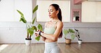 Woman, fitness and checking watch with time in gym for yoga preparation, zen or schedule. Active, female person or tracking app with wristwatch for heart rate, bpm or health and wellness in studio
