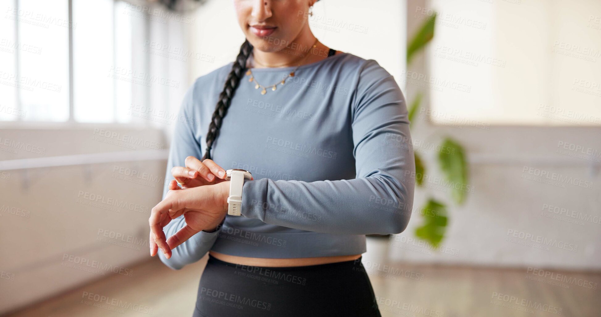 Buy stock photo Hands, woman and smart watch in studio for fitness, performance tracking or health information. Exercise, person and check wristwatch for timer, workout progress or heartbeat monitor for wellness