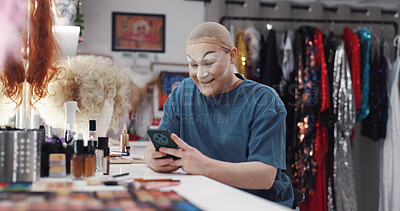 Buy stock photo Drag artist, dressing room and happy with smartphone, app and typing update for show on social media. Backstage, performer and person with mobile for self promotion, creative and browsing on website