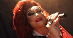 Person, drag artist and stage with singing at theater with toast, celebration and pride at event. Lgbt performer, champagne and voice with audience, thanks and makeup with microphone at cabaret show