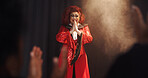 Person, drag artist and smile with thanks, stage and excited with respect for crowd at cabaret show. Lgbt performer, musician or singer with gratitude, happy and pride with prayer hands for audience
