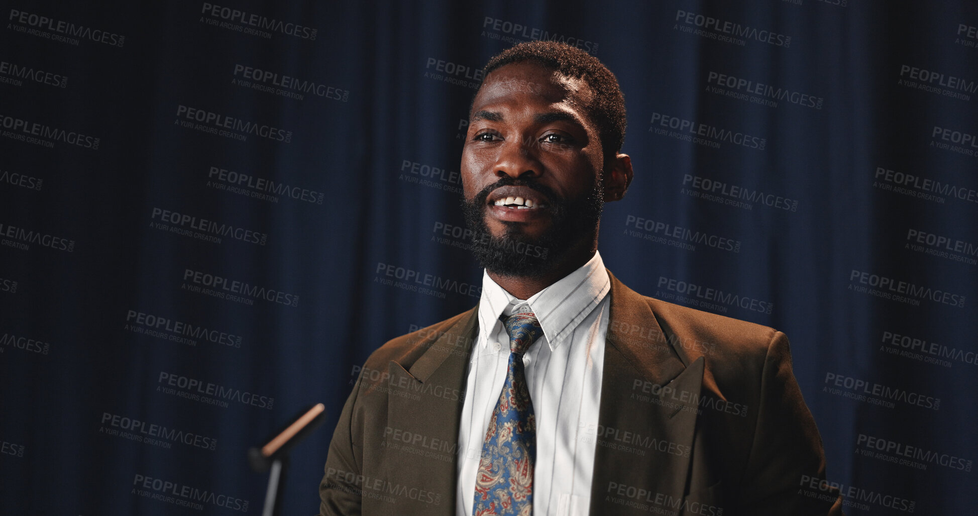 Buy stock photo Black man, speaker and convention with mic for speech, congress or political statement on podium. Event, male person or African politician with seminar for government pitch, democracy or election