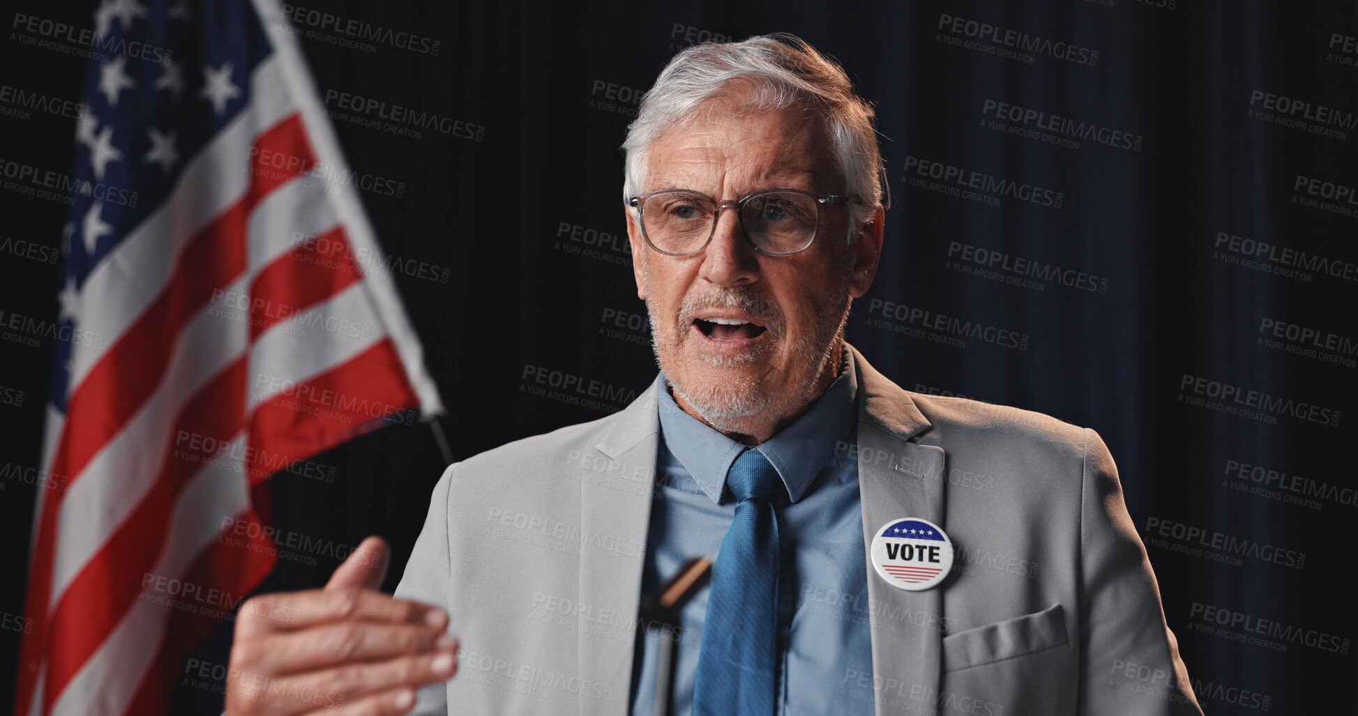 Buy stock photo Mature man, speaker and speech with american flag for global economic change, vote or opportunity. Male person, diplomat or political congress with mic for public relations or national election