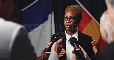 Buy stock photo Woman, press conference and talk with flags at international seminar, journalist group or interview at event. Person, speaker or ambassador with media, mic and ceasefire announcement for global war