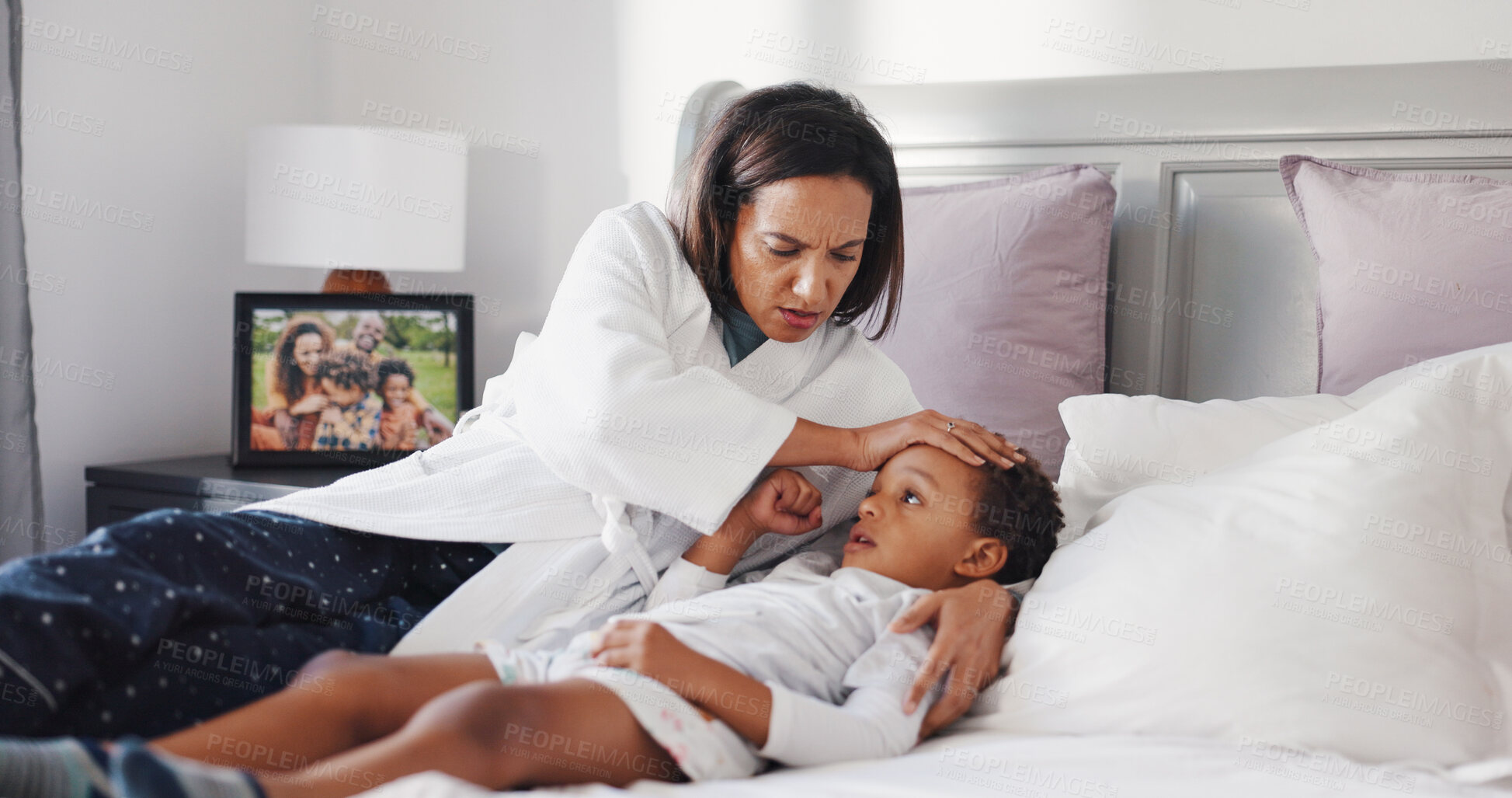 Buy stock photo Fever, sick and mother with child in bedroom for temperature check, support and healthcare. Virus symptoms, medical care and worry with woman and kid in bed of family home for flu monitor and love